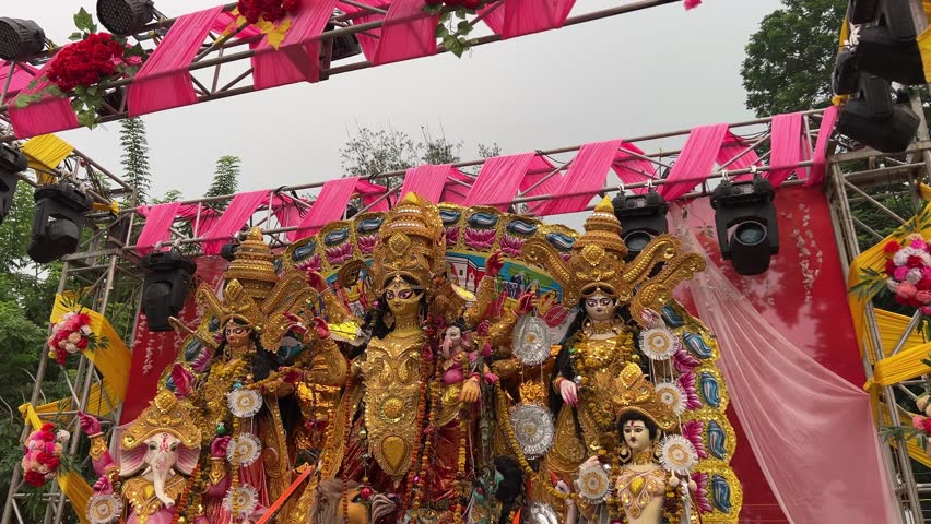 The Maa Durga idol stands majestically on an open stage, flanked by Laxmi, Saraswati, Ganesh, and Kartick.