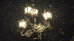 It is snowing against the background of the night sky and a beautiful glowing old street lamp in winter. - Powered by Shutterstock - Get 15% off with code: PIKWIZARD15