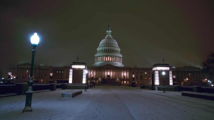 Capitol building in winter snow at night. Winter Capitol hill, Washington DC. Capitols dome in winter night snow. After the Snow Washington DC. United States capitol building in the snow.