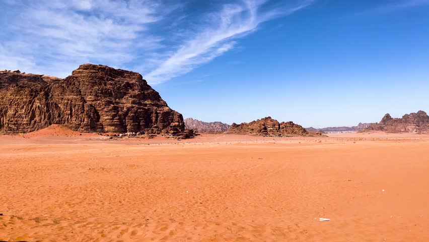 Majestic shot of an empty desert showing amazing rock formation under a blue cloudy sky