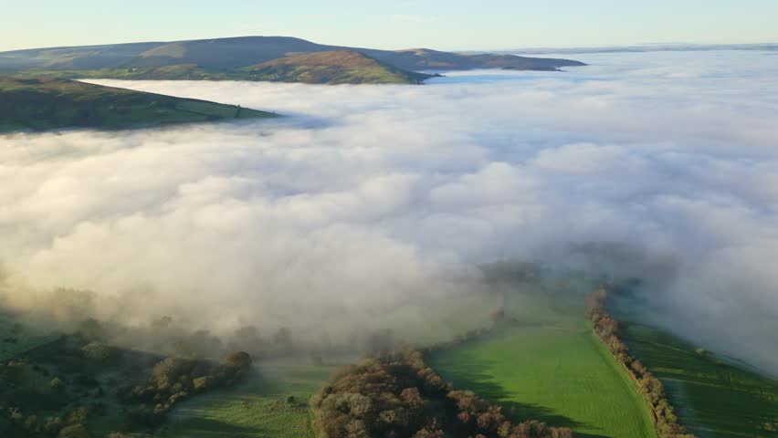 Aerial view of thick fog over rural countryside at dusk (Brecon Beacons)
