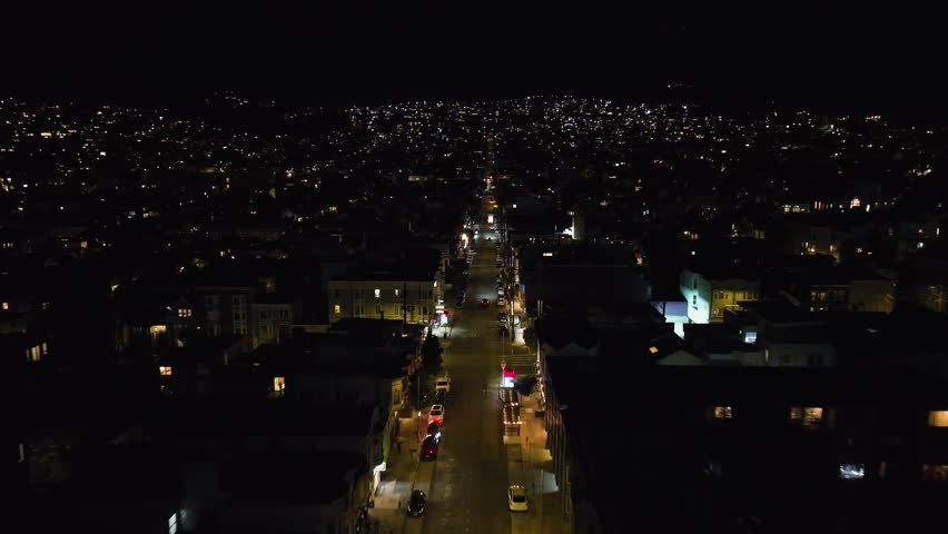Drone following a car on quiet streets of San Francisco city, night in CA, USA