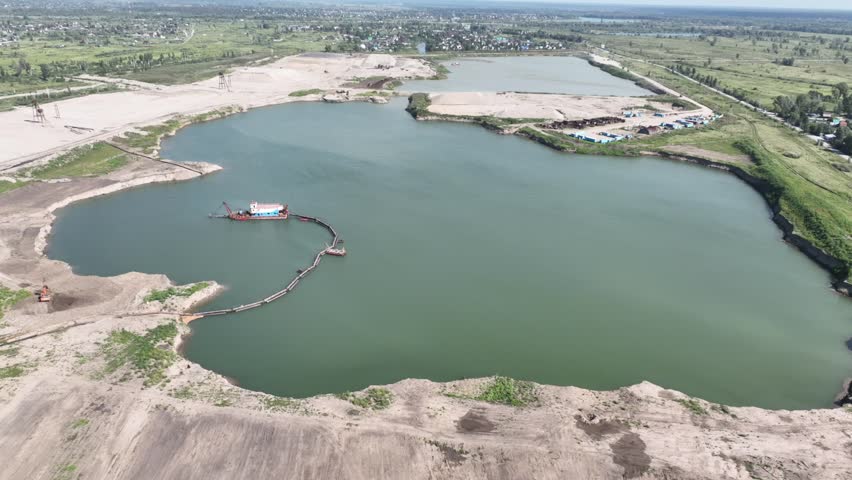 Drone view of a sand quarry near a lake. 