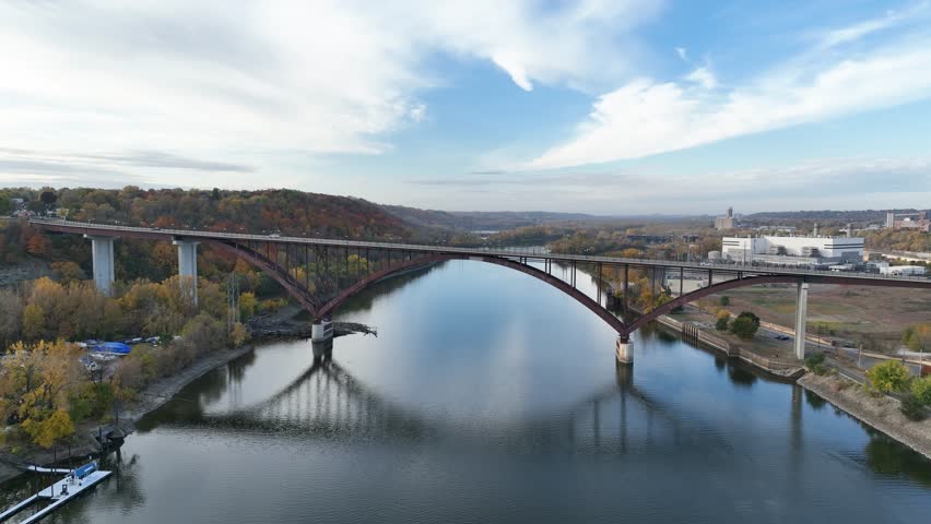 Aerial flyby shot above the Mississippi river near St Paul at Minnesota over Smith Avenue high bridge in USA.