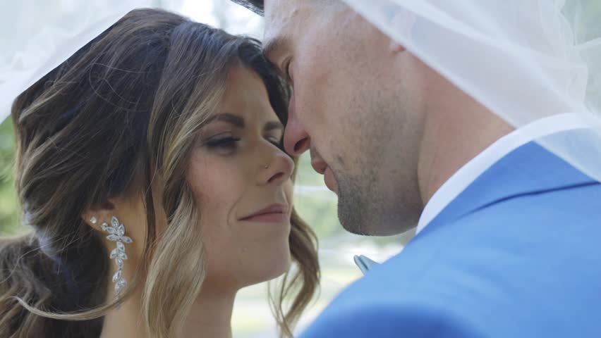 Groom kisses beautiful bride on the cheek