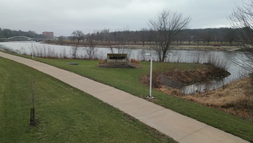 The city limit sign for Iowa City next to the Iowa River. 