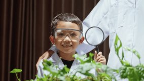 Smiling Young Scientist Boy Holding Magnifying Glass in Laboratory, Close-Up of Child Learning Science and Experimenting, Future Career Education Concept - Powered by Shutterstock - Get 15% off with code: PIKWIZARD15