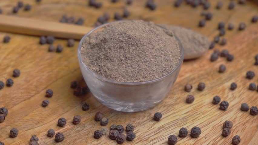 Rotating Shot of Black Pepper (Kali Mirch) and Powder