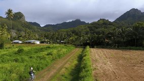 Girl cycling through the scenic paths of Rarotonga, Cook Islands - Powered by Shutterstock - Get 15% off with code: PIKWIZARD15