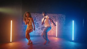 Hip-hop dance style with ethnic elements, man and woman dancing together in hall . Attractive African American people enjoying rhythmical music in rehearsal hall, contemporary dance styles for youth - Powered by Shutterstock - Get 15% off with code: PIKWIZARD15