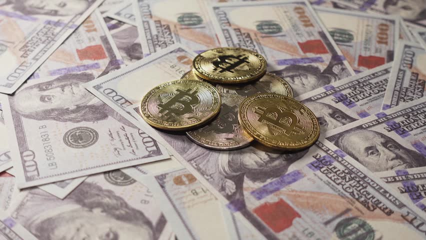 Bitcoin Amid Hundred Dollar Bills, Bitcoin and US dollars in slow motion. Finance and investment concept