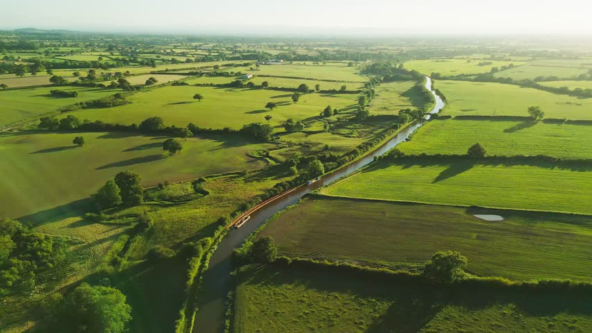 An Aerial view of sunset over the Cheshire rural landscape with green fields