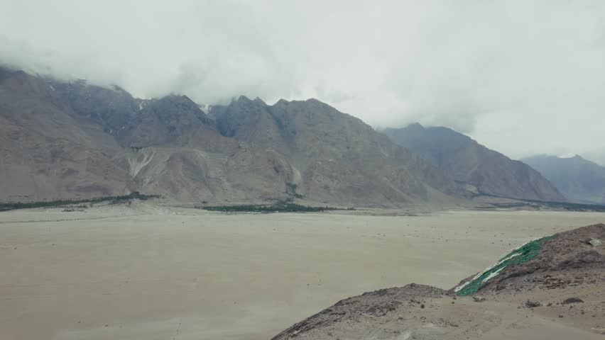 The Indus River flowing in a mountainous valley during a cloudy daytime in Skardu city, Gilgit-Baltistan, Pakistan