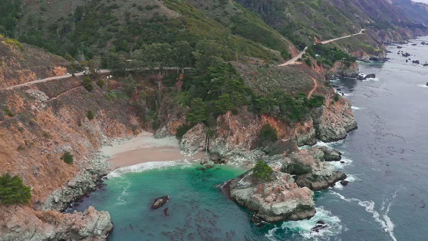 Aerial view of McWay Falls on the Pacific coast along Highway 1 in California. Big Sur, Lucia. Travel concept, tourism, journey, vacation. 4K video.