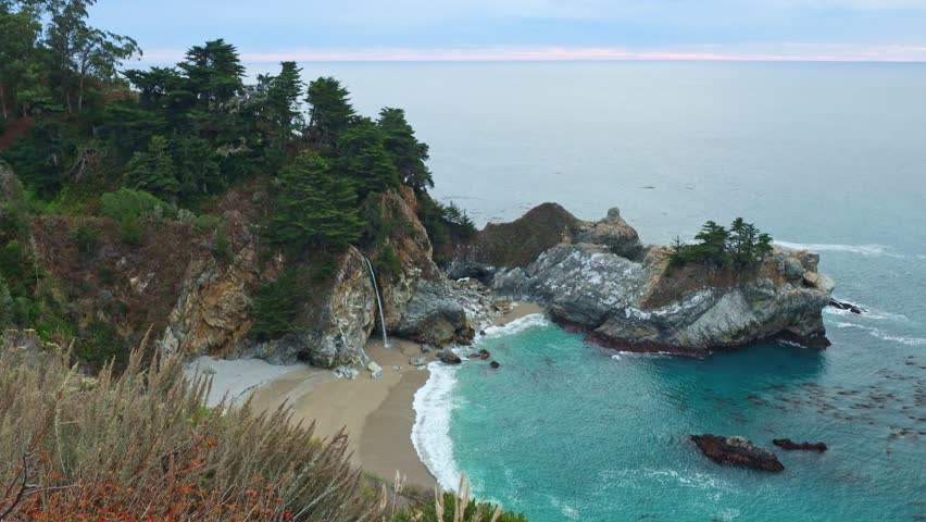 Aerial view of McWay Falls on the Pacific coast along Highway 1 in California. Big Sur, Lucia. Travel concept, tourism, journey, vacation. 4K video.