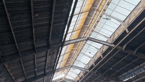 Industrial Roof Structure Showcasing Natural Light Filtering Through Skylights in a Large Warehouse Setting - Powered by Shutterstock - Get 15% off with code: PIKWIZARD15