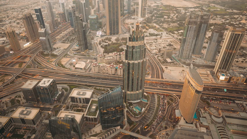 Day to night timelapse of Dubai city center with modern tall skyscrapers and busy street traffic on a highway. Time lapse of Dubai with bright city lights at night, Dubai, UAE
