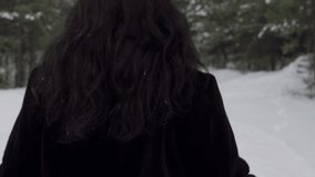 Happy woman removing jacket while running amidst trees. Portrait of smiling female dancing on snow covered pathway. She is enjoying winter in forest. - Powered by Shutterstock - Get 15% off with code: PIKWIZARD15