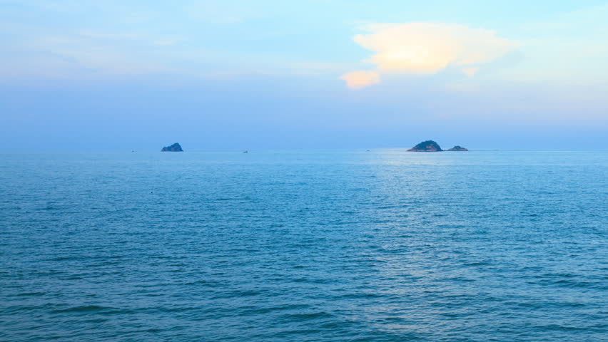 A landscape of sea, islands and sky at dusk, Thailand. 4K 3840x2160. Pan right and wide shot. Time lapse. Can be establishing shot.