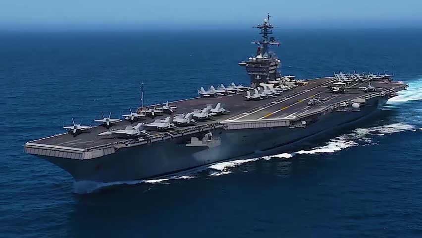 US Navy aircraft carrier heads out to sea at full power