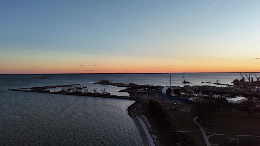 Shifting perspectives over Chesapeake Bay as the sun dips into the back side of the horizon and commuters are engulfed by the sea as they enter the tunnel beneath the water.