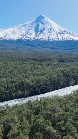 Osorno Vulcan At Petrohue Los Lagos Chile. Breathtaking Of Iconic Snow Capped Volcano Landscape. Nature Travel Snow Covered Forest Trees. Nature Aerial Landscape. Petrohue Los Lagos.