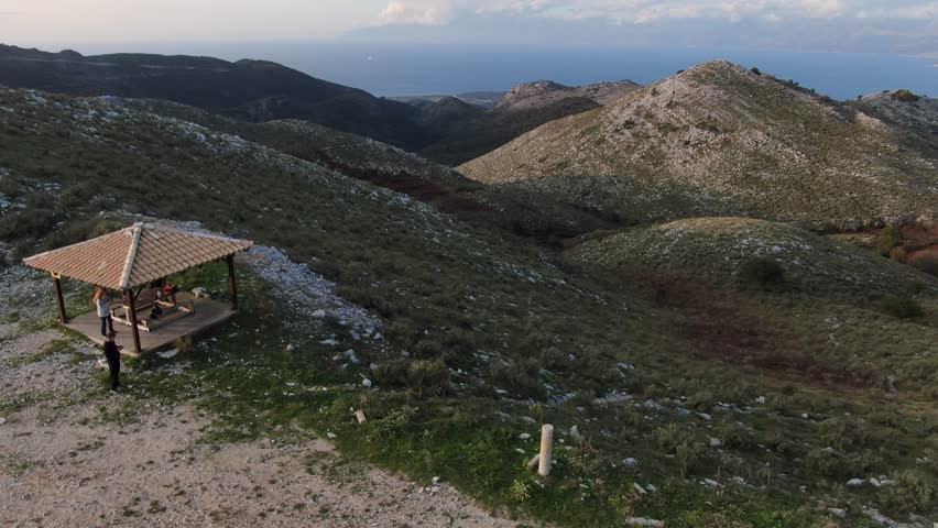Coastal mountain range and winding road overlooking the sea