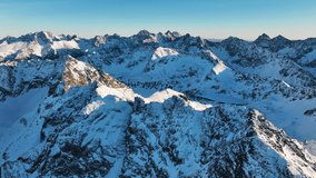Majestic snow-covered mountains under clear skies capture the beauty of the alpine landscape at sunrise - Powered by Shutterstock - Get 15% off with code: PIKWIZARD15