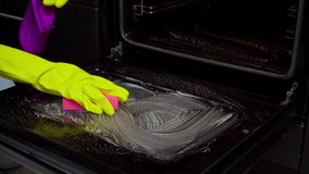 Effectively Cleaning an Oven with Protective Gloves and a Sponge for a Thorough Shine - Powered by Shutterstock - Get 15% off with code: PIKWIZARD15