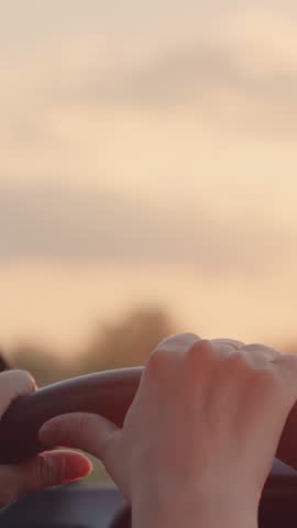female driver, steering wheel grip, road trip, sun flare hand, journey driving, woman at wheel, travel adventure, driving sunlight glare, car control hand, automobile navigation, female traveler.