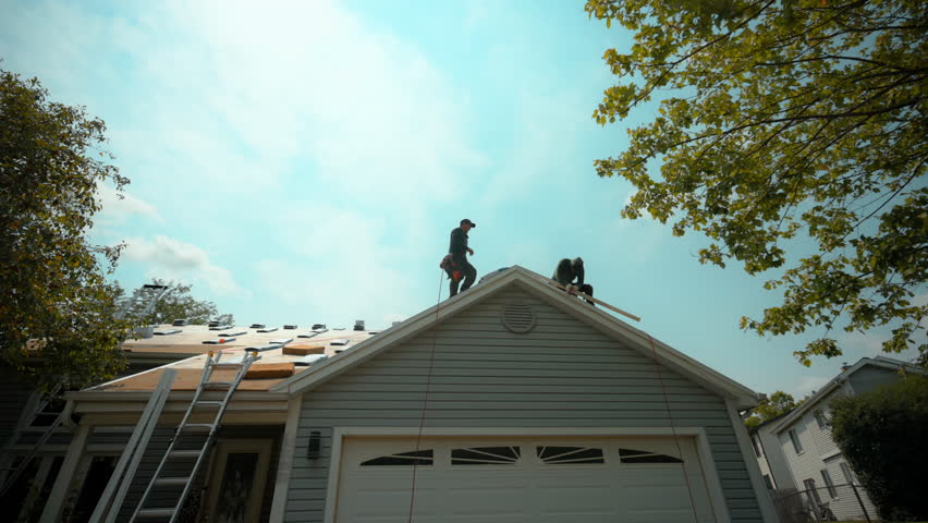 Element of Roofers installing a new roof on an house. Wide footage