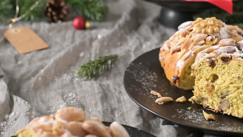 A festive Bolo Rainha, a traditional Portuguese Christmas cake filled with nuts, raisins, and candied fruit, dusted with powdered sugar