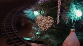 A Festive Christmas Tree adorned with a Heart Ornament and a charming Train Track design - Powered by Shutterstock - Get 15% off with code: PIKWIZARD15