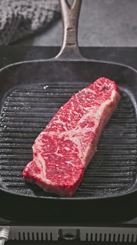 delicious juicy wagyu beef steak meat cooking on a grill pan. Process of making perfect steak at home