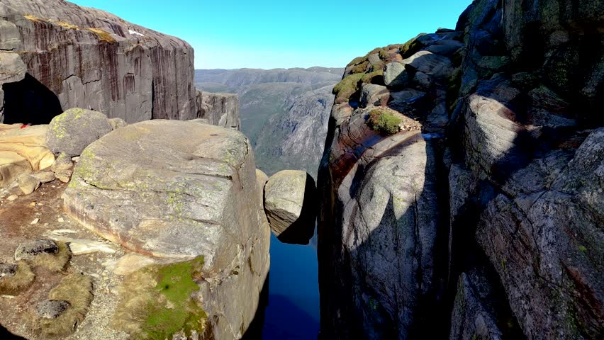 Norway majestic landscape featuring towering cliffs and unique rock formations. Experience the serene beauty and wonder of nature artistry in this remarkable location. Kjeragbolten Lysefjorden
