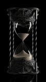 A slow pan towards an ornate antique brass hourglass sand timer with sand falling on a dark black background  - Powered by Shutterstock - Get 15% off with code: PIKWIZARD15