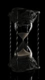 A slow pan around an ornate antique brass hourglass sand timer with sand falling on a dark black background  - Powered by Shutterstock - Get 15% off with code: PIKWIZARD15