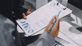 Two business leaders talk about charts, financial graphs showing results are analyzing and calculating planning strategies, business success building processes. - Powered by Shutterstock - Get 15% off with code: PIKWIZARD15