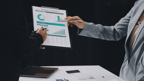 Two business leaders talk about charts, financial graphs showing results are analyzing and calculating planning strategies, business success building processes. - Powered by Shutterstock - Get 15% off with code: PIKWIZARD15