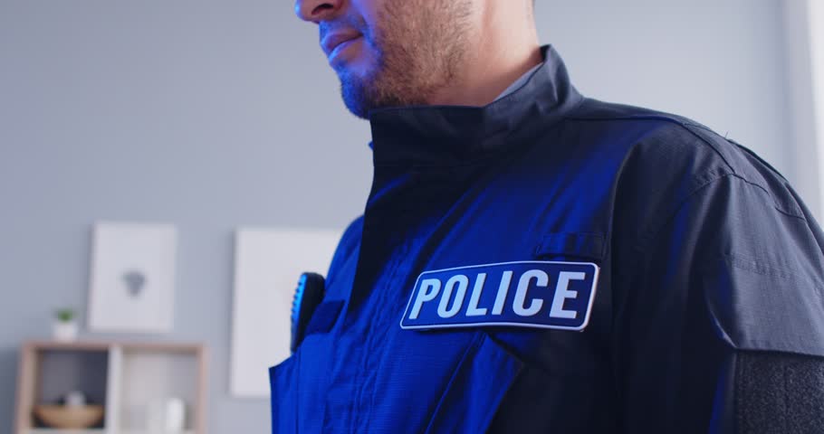 Police security guard using walkie-talkie radio, talking system to broadcast communication between police officers, dispatchers, calling for help, signaling about crime, reporting an incident, arrest