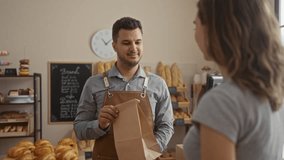 Man and woman interacting indoors in a bakery with bread displays in the background - Powered by Shutterstock - Get 15% off with code: PIKWIZARD15
