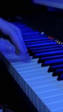 Professional musician playing electric piano keyboard. Musician playing synthesizer at dark music sound recording studio. Vertical video - Powered by Shutterstock - Get 15% off with code: PIKWIZARD15