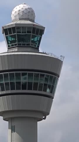 airport control tower (atc) standing against cloudy sky key infrastructure for air traffic management communication static shot atc aviation