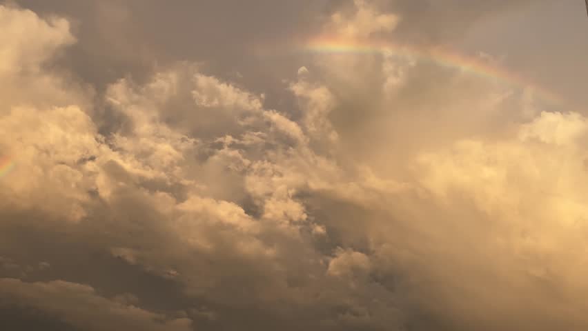 4k beautiful golden sunset sky in the rice fields with billowing clouds and a beautiful rainbow after rain
