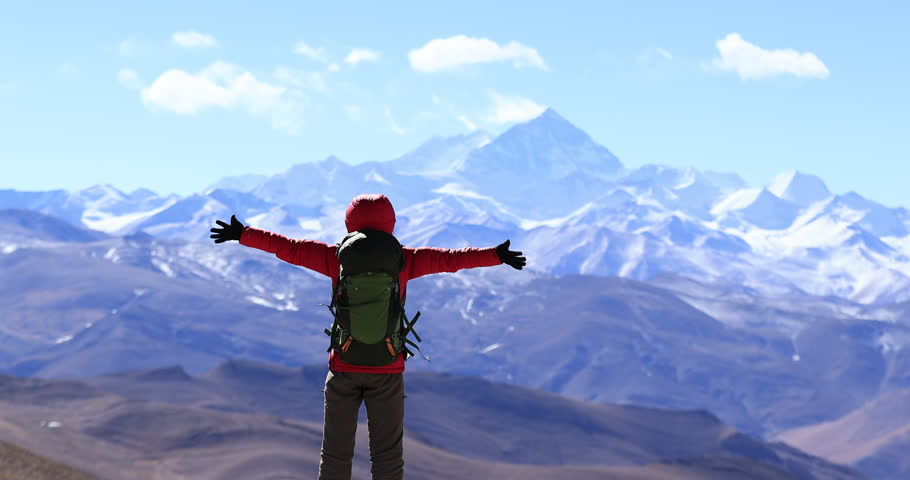 Successful woman hiker open arms to Mount Everest in Tibet, China