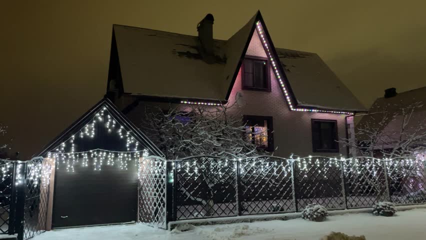 A Festive House Beautifully Decorated with Glowing Christmas Lights During Winter Evenings