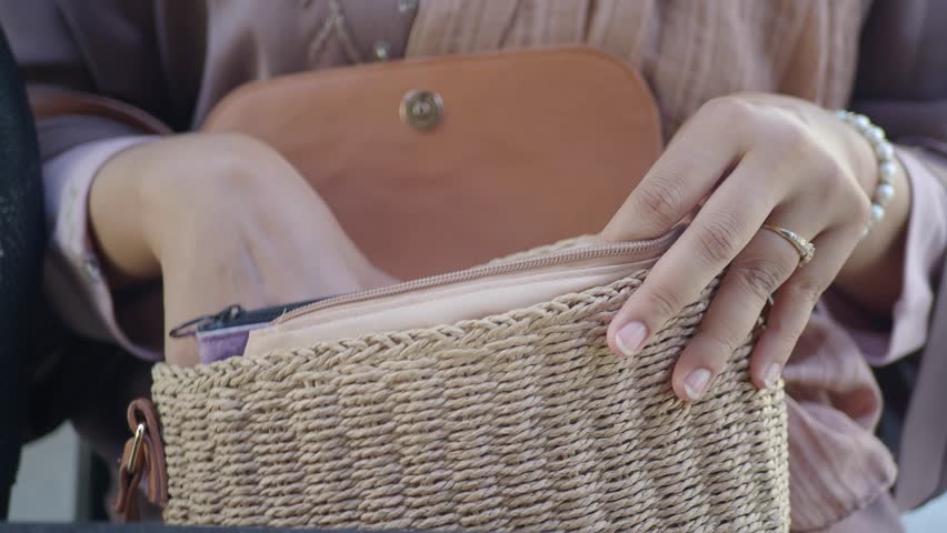 women looking for something in her purse