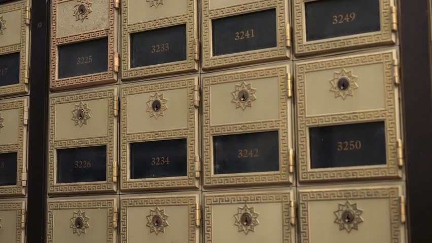 A detailed closeup view of vintage mailboxes that showcases their intricate designs and special numbering