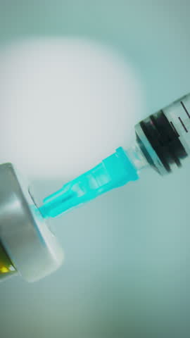 A sterile environment showcases a medical professional preparing a syringe. The vial releases a vibrant blue liquid, indicating a careful and precise process essential for patient care