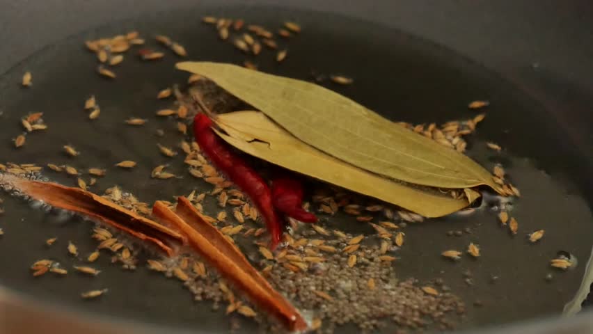 Indian Spice Tempering in Hot Oil.Sizzling Spices in Oil Close-Up.